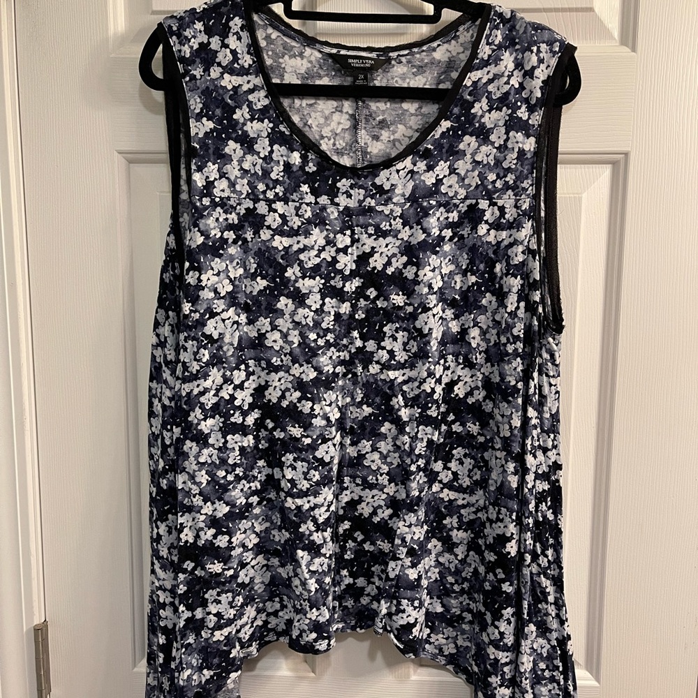 Sleeveless top with shark bite hem